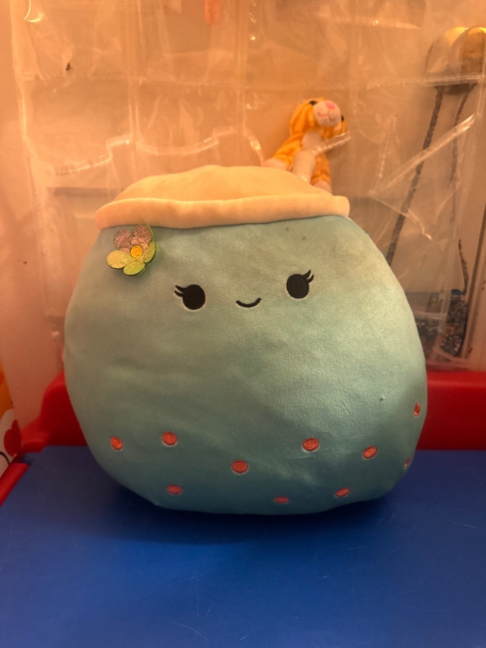 Squishmallows Jakarria Blue Boba plush featuring a straw and a small flower acce
